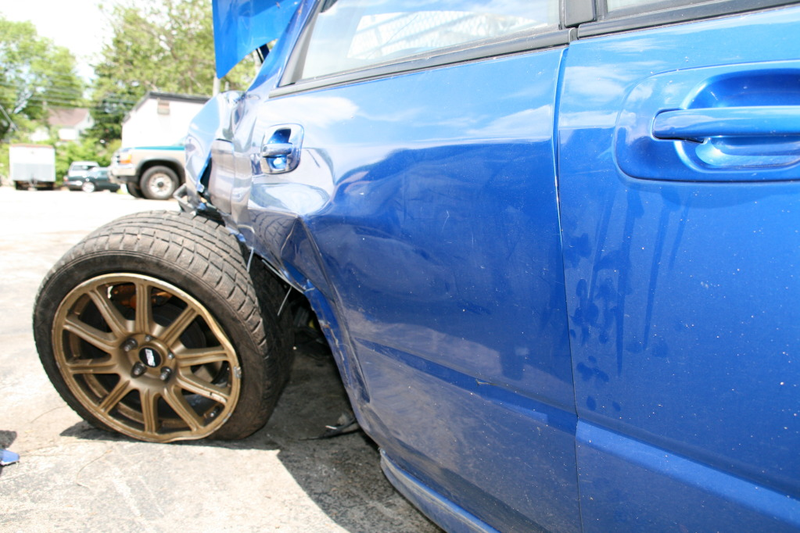 Illustration for article titled Subaru STI Hits Two Trees At Speed, Flips Twice, Everyone Survives!